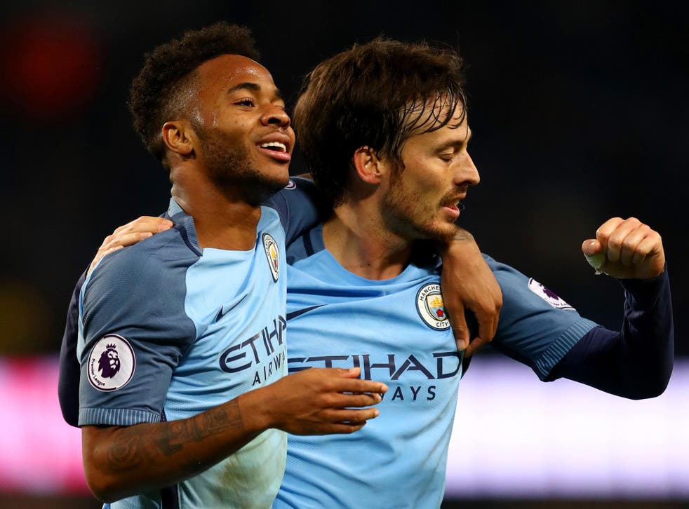 Raheem Sterling celebrates with David Silva after scoring Manchester City's second against Arsenal