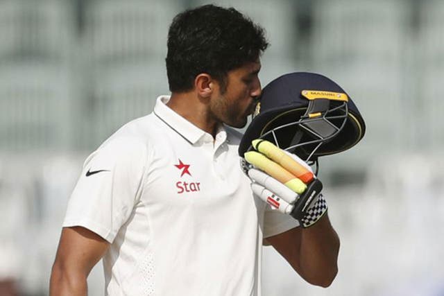 Karun Nair kisses the badge on his helmet after reaching his double century
