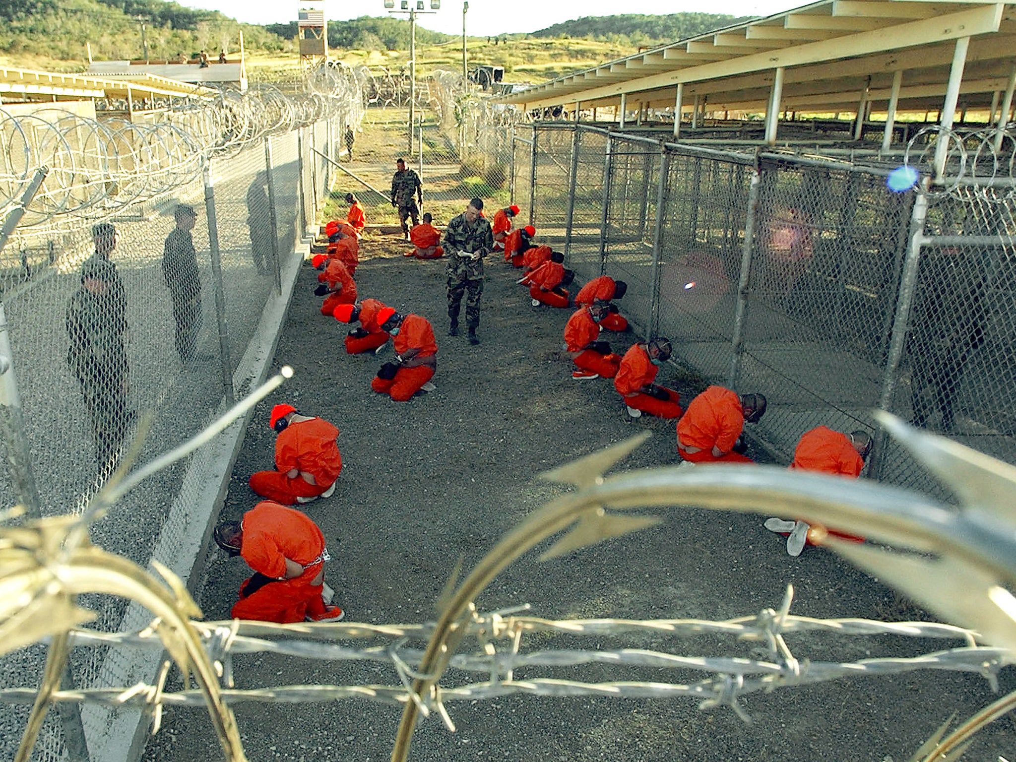 This photo shows hooded inmates at the Guantanamo Bay prison, where both men are being held