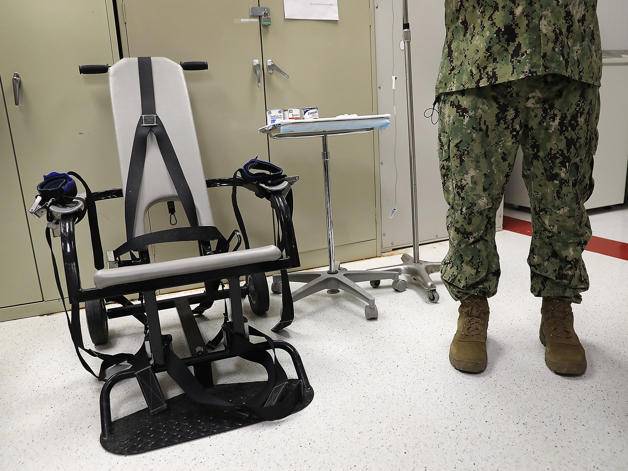 A US Navy doctor displays a restraint chair in the detainee clinic in the ‘Gitmo’ maximum security detention center at the US Naval Station at Guantanamo Bay, Cuba