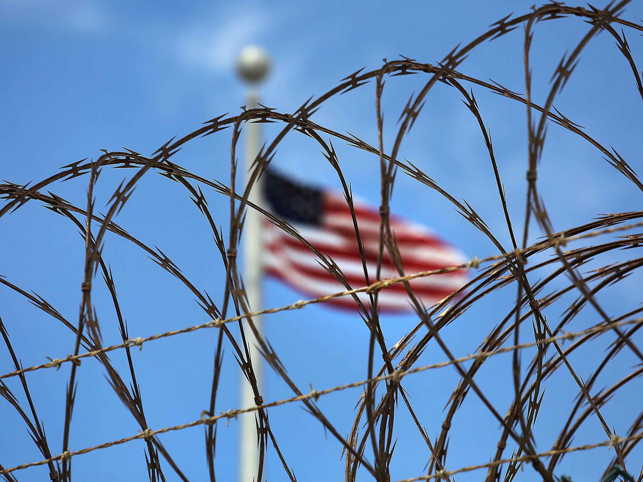 Razor wire tops the fence of the US prison at Guantanamo Bay