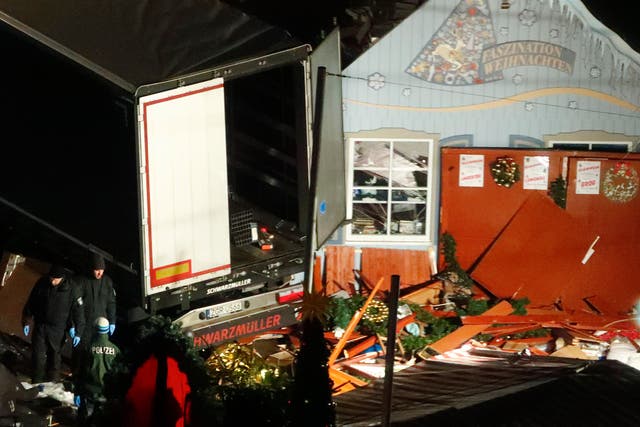 Police investigators inspect a truck that ploughed through a crowd of a Christmas market on Breitscheidplatz square near the fashionable Kurfuerstendamm avenue in the west of Berlin, Germany