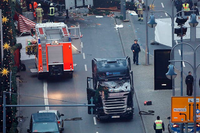 A tow truck operates at the scene where a truck ploughed through a crowd at a Christmas market on Breitscheidplatz square near the fashionable Kurfuerstendamm avenue in the west of Berlin, Germany