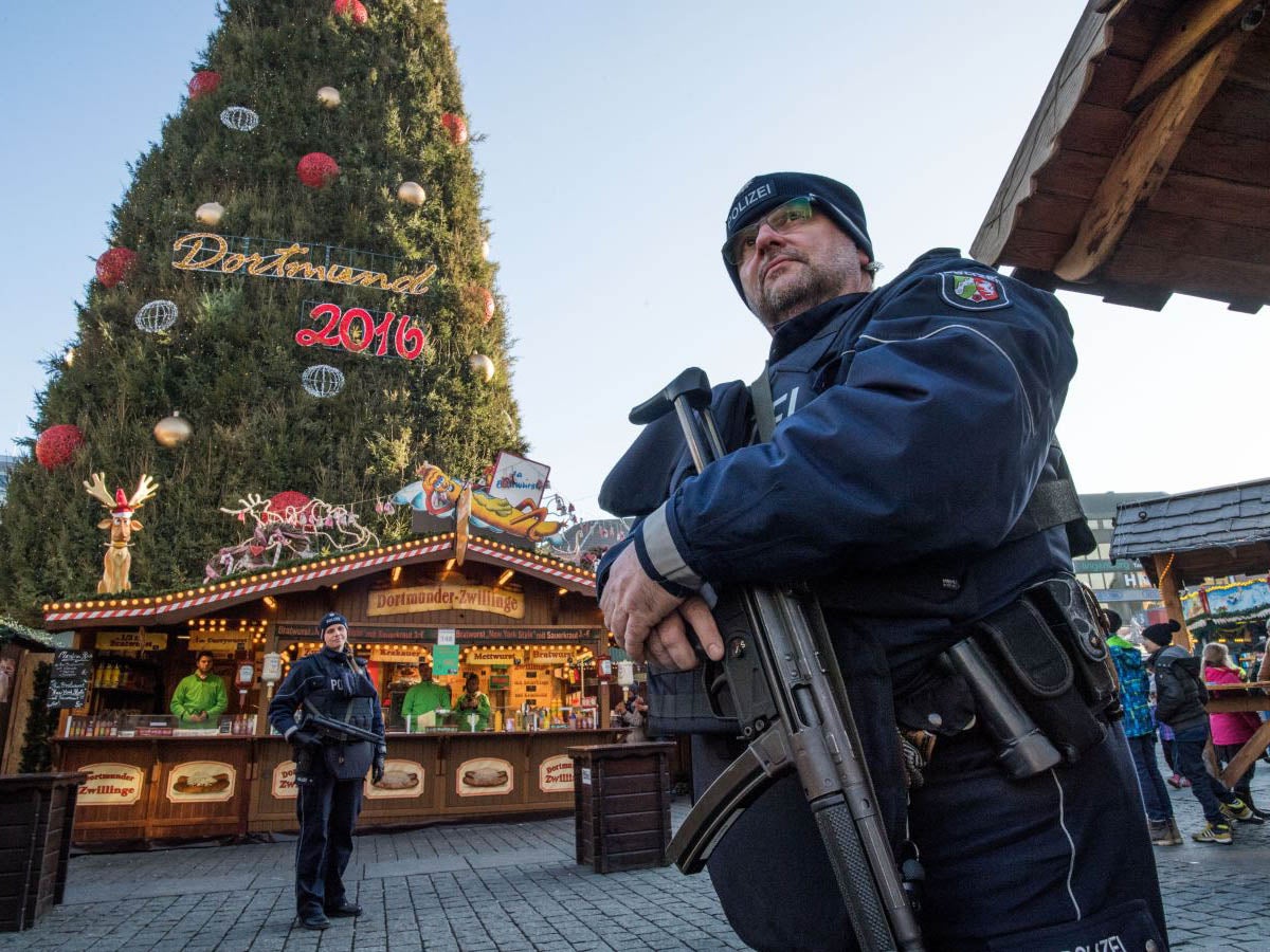 Police officers carrying  machine guns patrol at the Christmas market in Dortmund, Germany