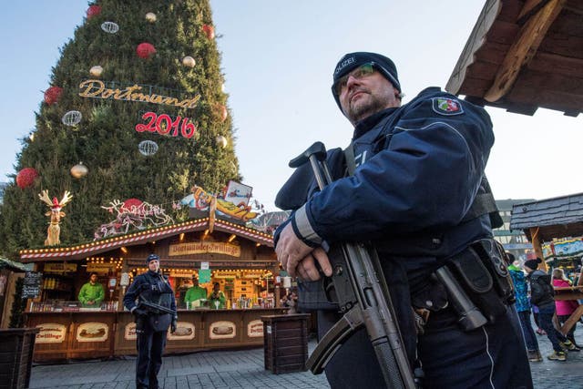 Police officers carrying  machine guns patrol at the Christmas market in Dortmund, Germany