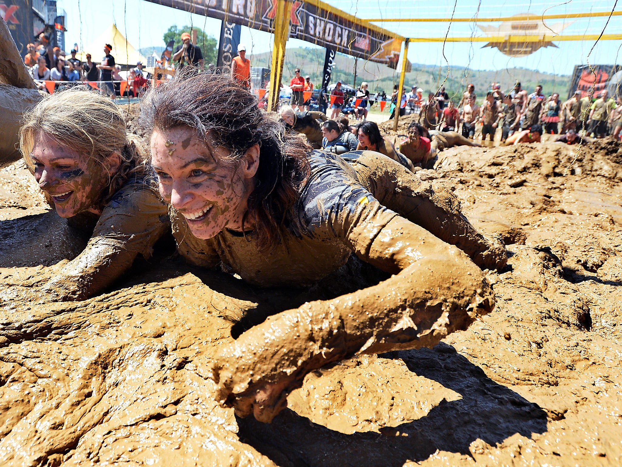 Fitness fanatics take on 'Tough Mudder' challenge: crawling is being described as the new plank