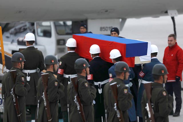 The flag-wrapped coffin of ambassador  Andrei Karlov is carried to a plane during a ceremony at Esenboga airport in Ankara