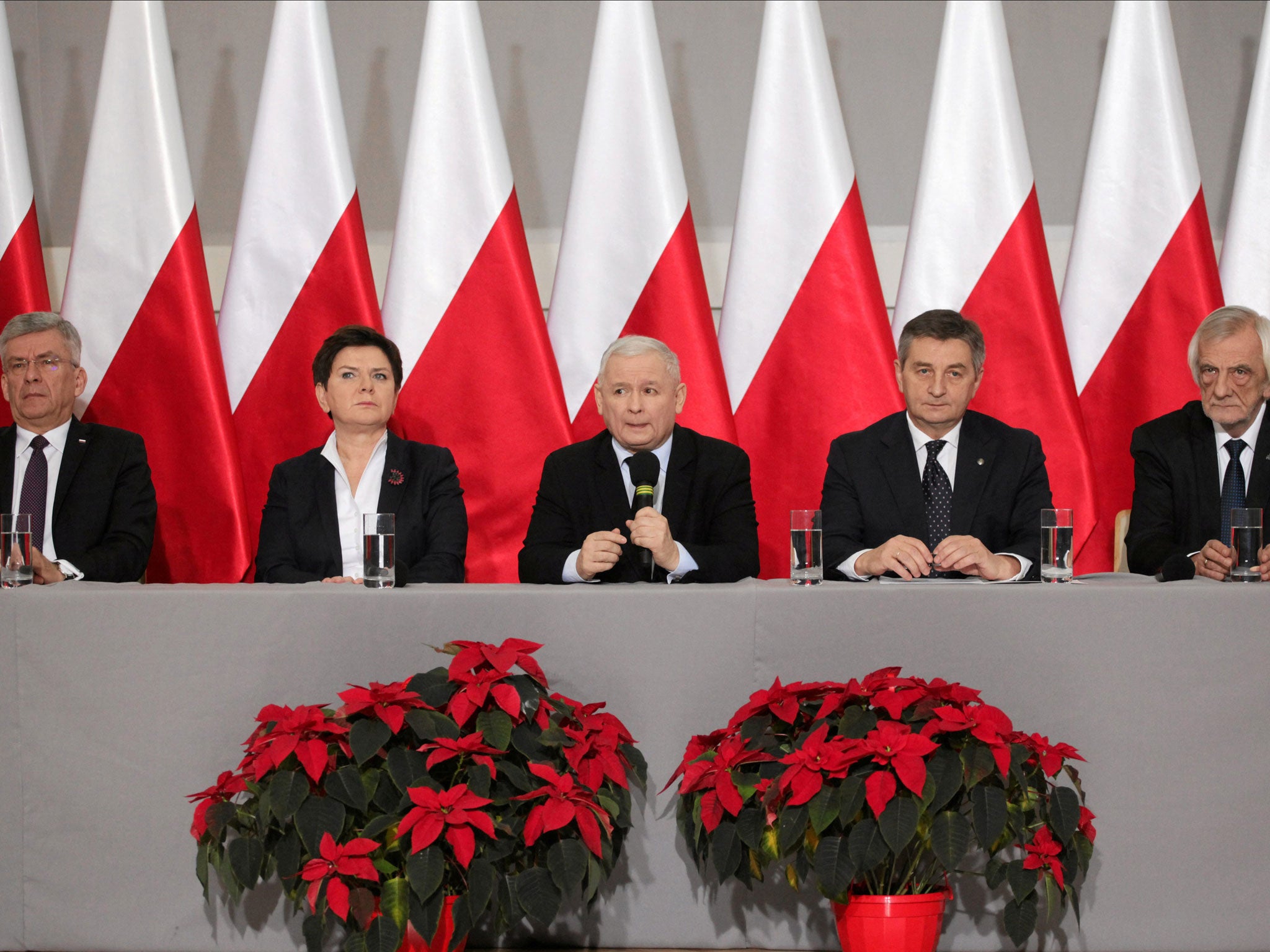 Leader of Law and Justice party Jaroslaw Kaczynski, centre, claims the country could see a 'great calamity' over recent protests 