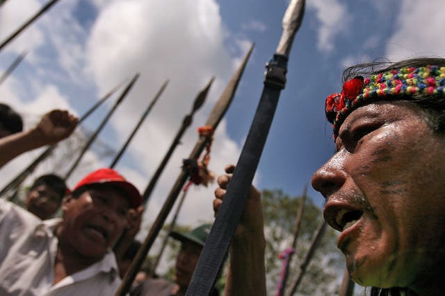 Natives armed with spears set a road blockage at the entrance of the Amazonian town of Yurimaguas, northern Peru