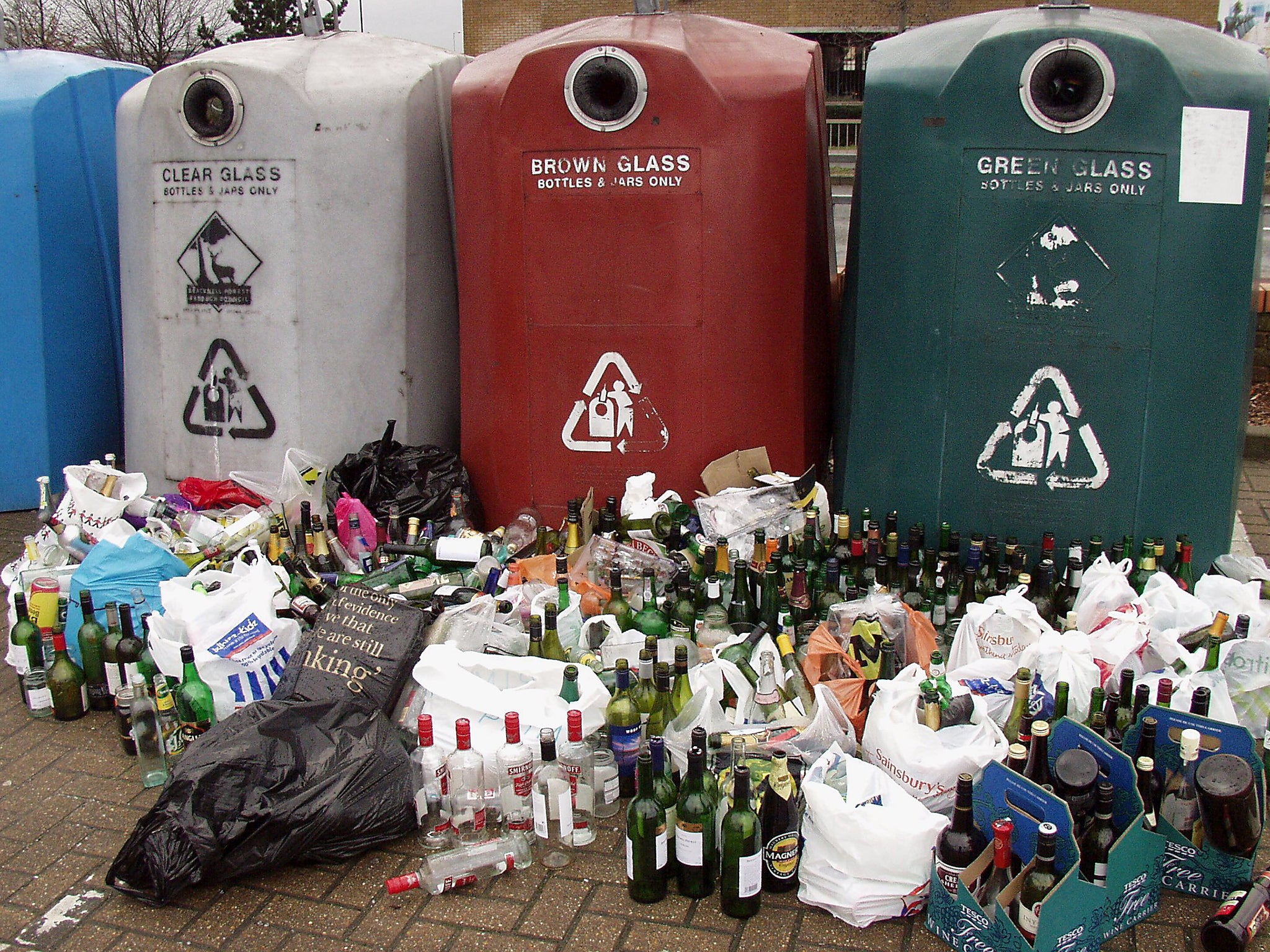 An overflowing recycling bottle bank after Christmas festivities