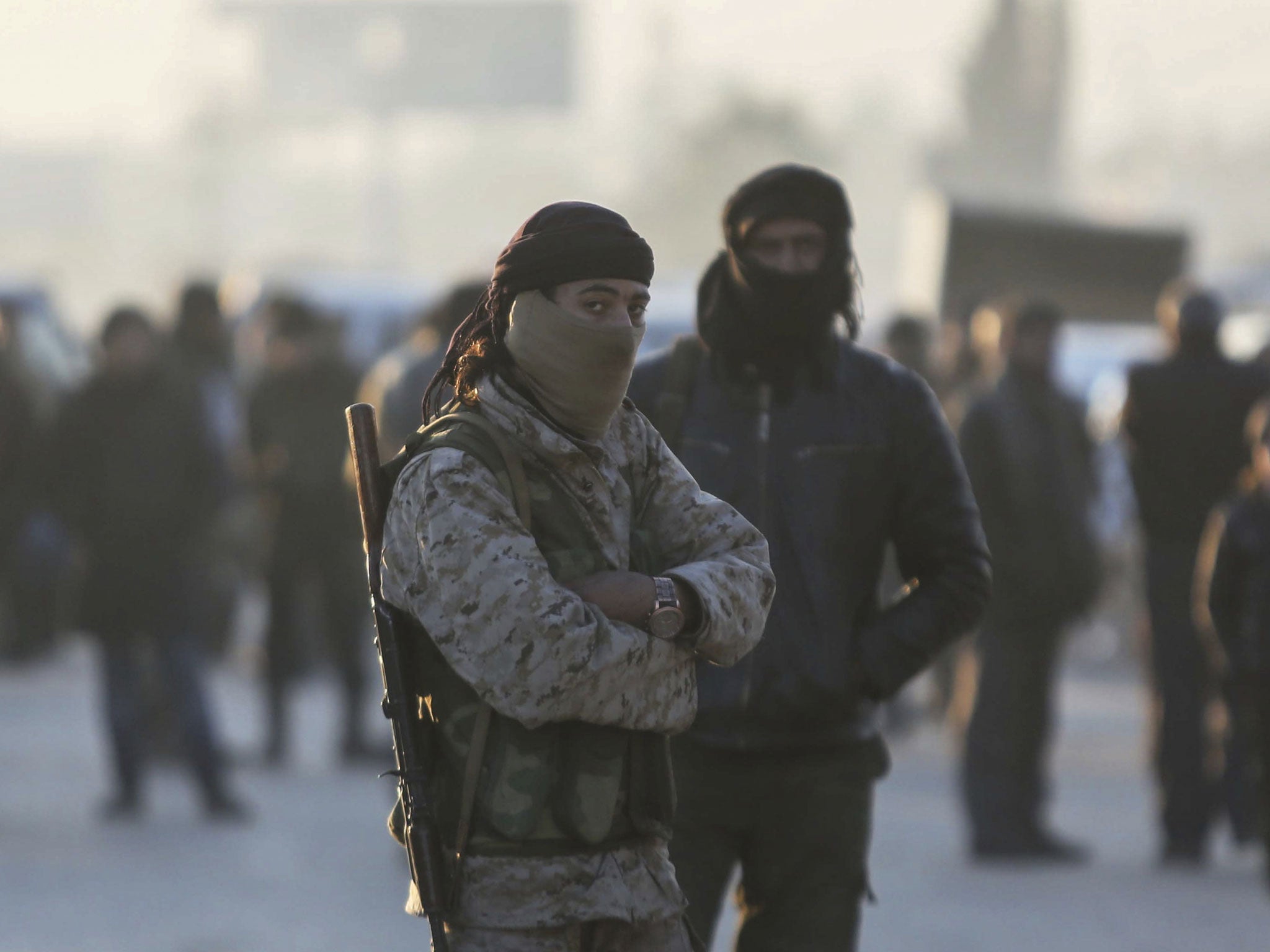 Armed Syrian fighters evacuated from Aleppo arrive alongside civilians at a refugee camp in Rashidin, near Idlib