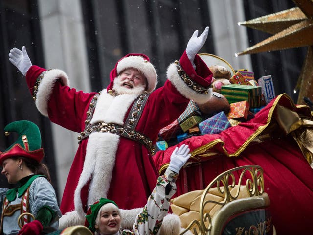 Santa Claus waves to the crowd during a parade in New York City
