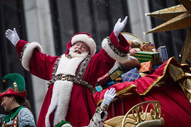 Santa Claus waves to the crowd during a parade in New York City