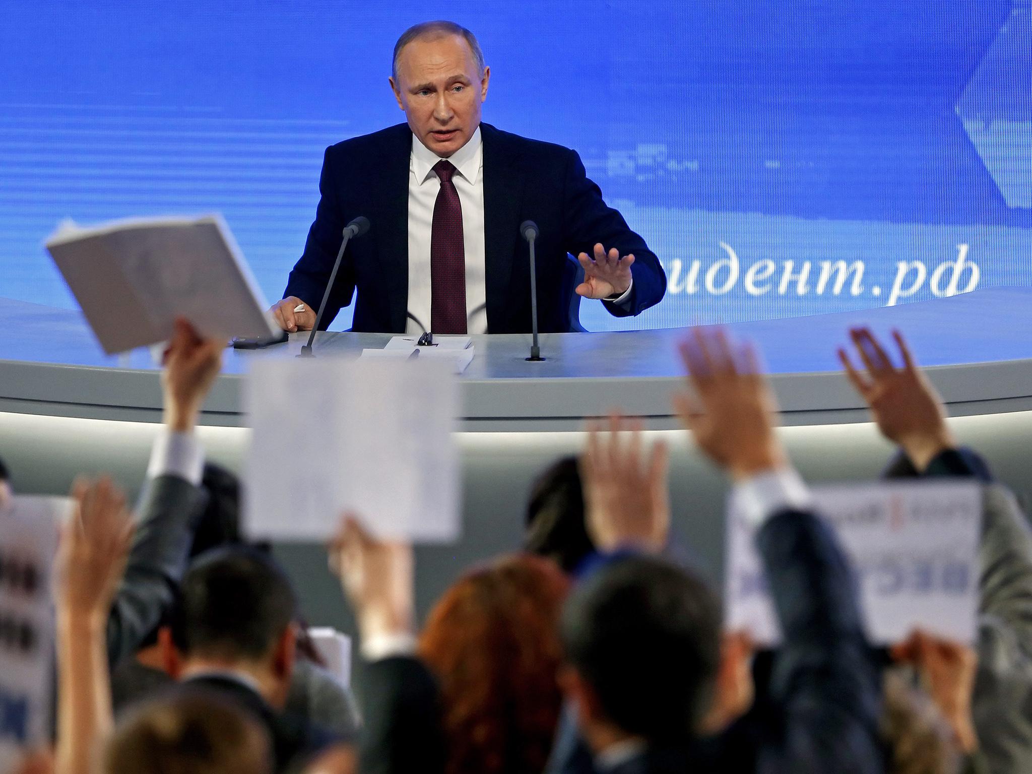 Vladimir Putin fields questions during his annual press conference in Moscow
