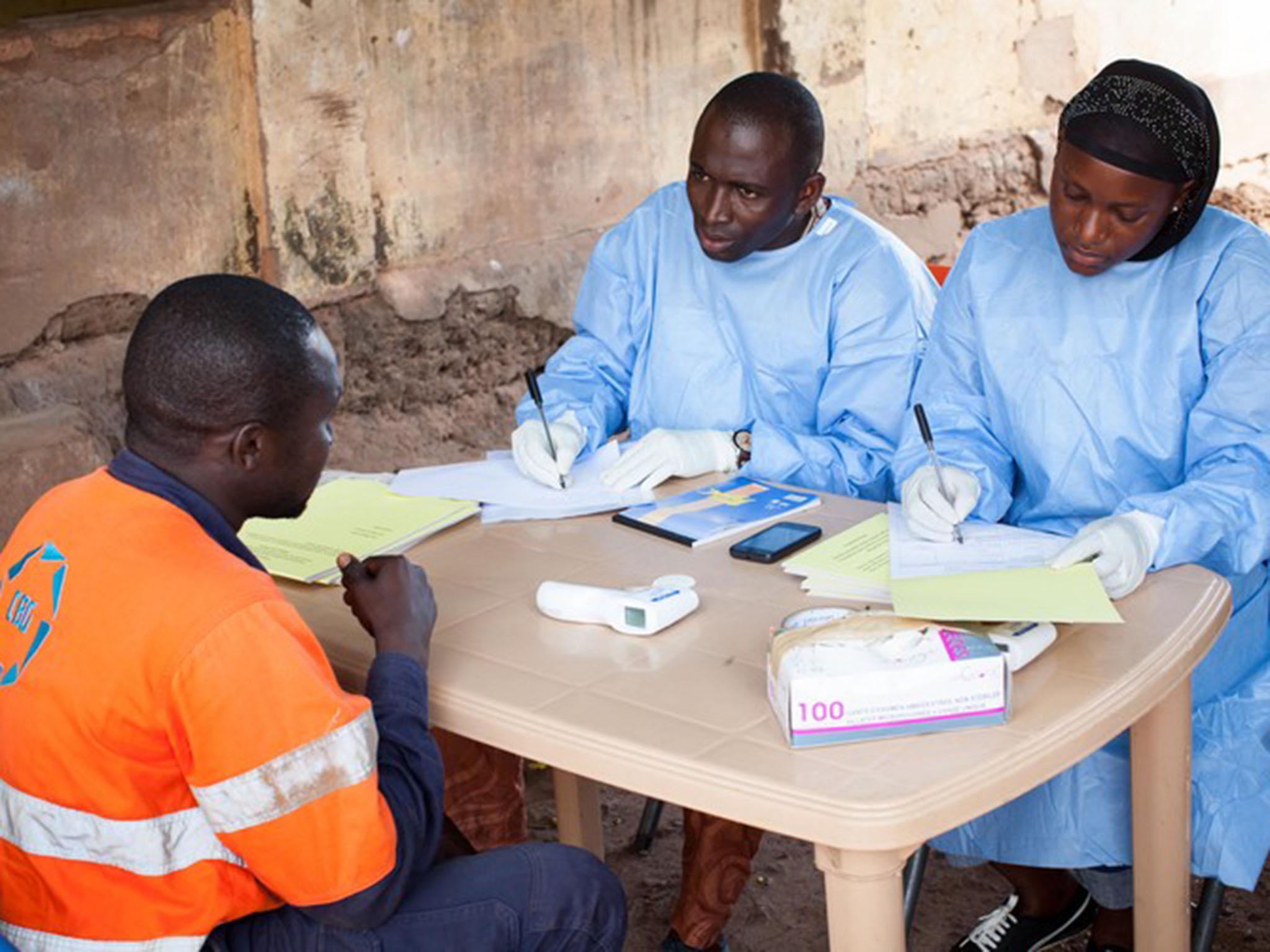 Health officials process samples in the Ebola lab at Donka Hospital in Conakry, Guinea