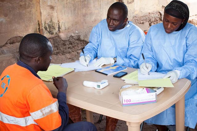 Health officials process samples in the Ebola lab at Donka Hospital in Conakry, Guinea