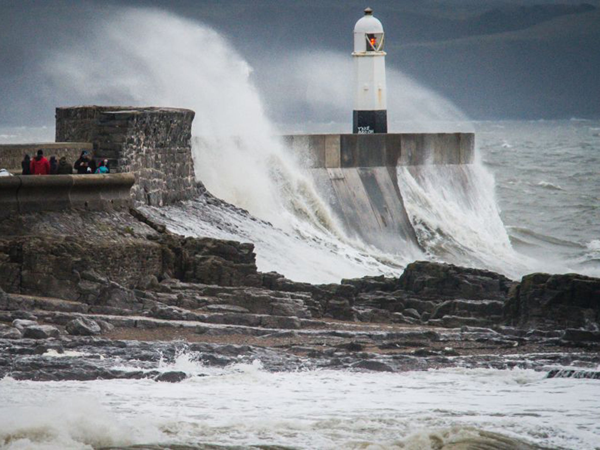 Waves crash over the harbour wall at Porthcawl during Storm Barbara