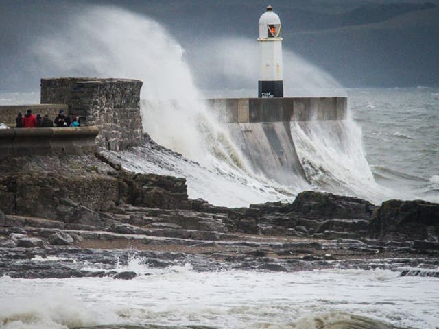  Waves crash over the harbour wall at Porthcawl during Storm Barbara