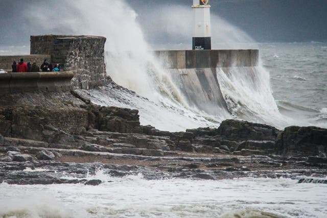  Waves crash over the harbour wall at Porthcawl during Storm Barbara