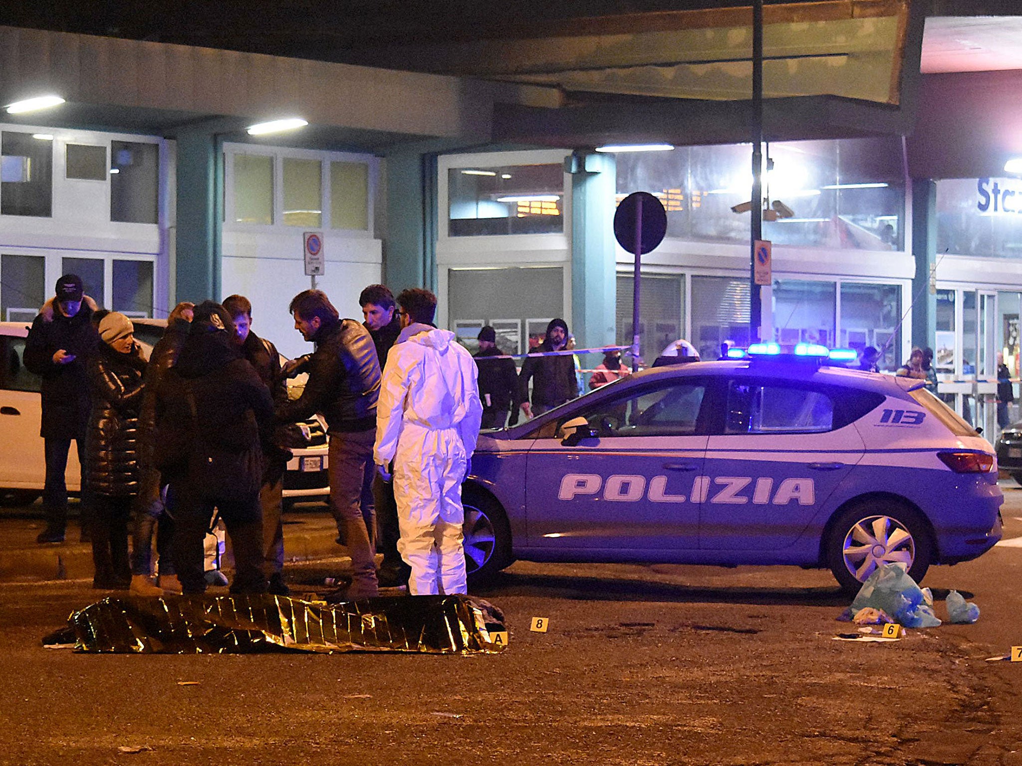 Italian police and forensics experts surround Anis Amri's body in Milan in the early hours of Friday morning Daniele Bennati/AFP/Getty