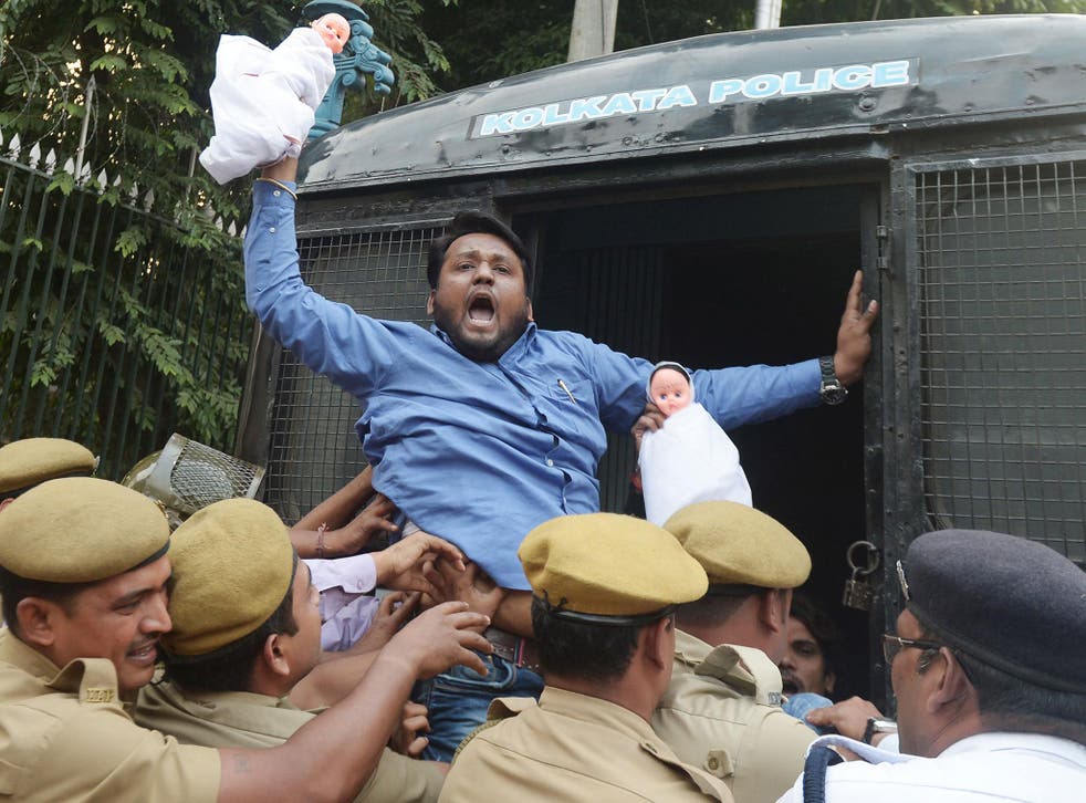 A student holds a doll aloft during a protest in Kolkata this month after 18 people were arrested for child smuggling