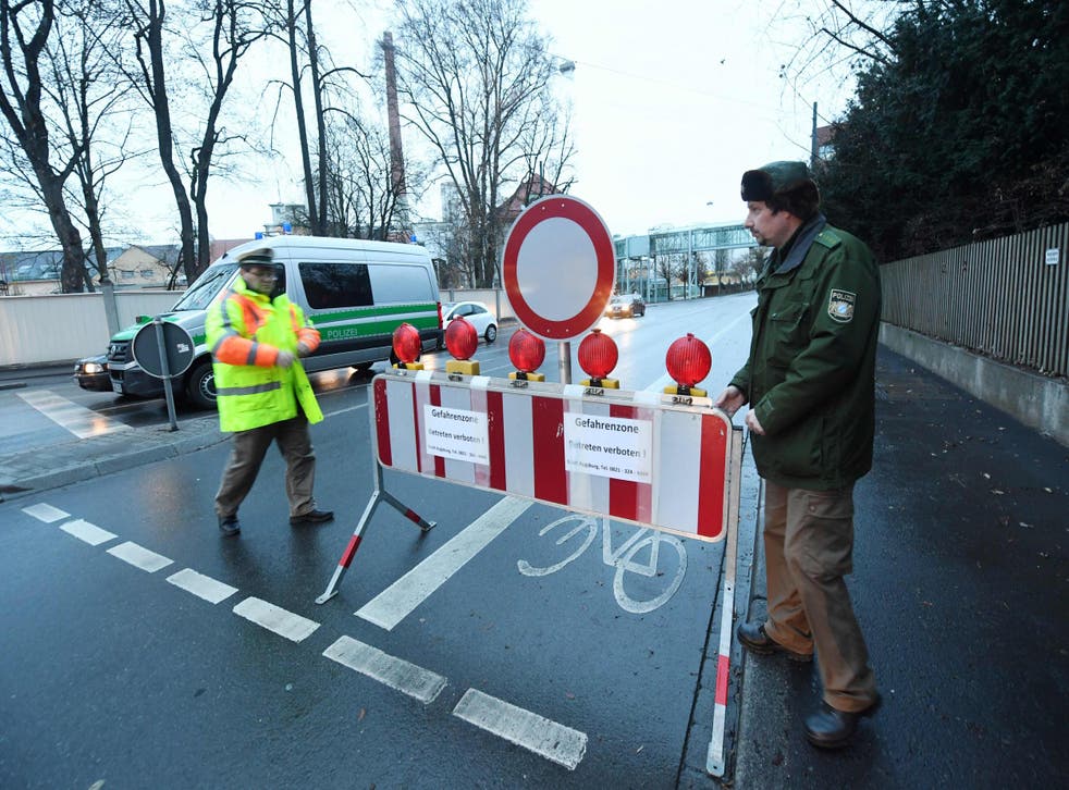 Policemen place a road block in Augsburg, as around 54,000 residents are evacuated