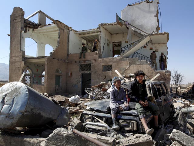 Children sit amidst the rubble of a house hit by Saudi-led coalition air strikes two days earlier on the outskirts of the Yemeni capital Sanaa on November 14, 2016