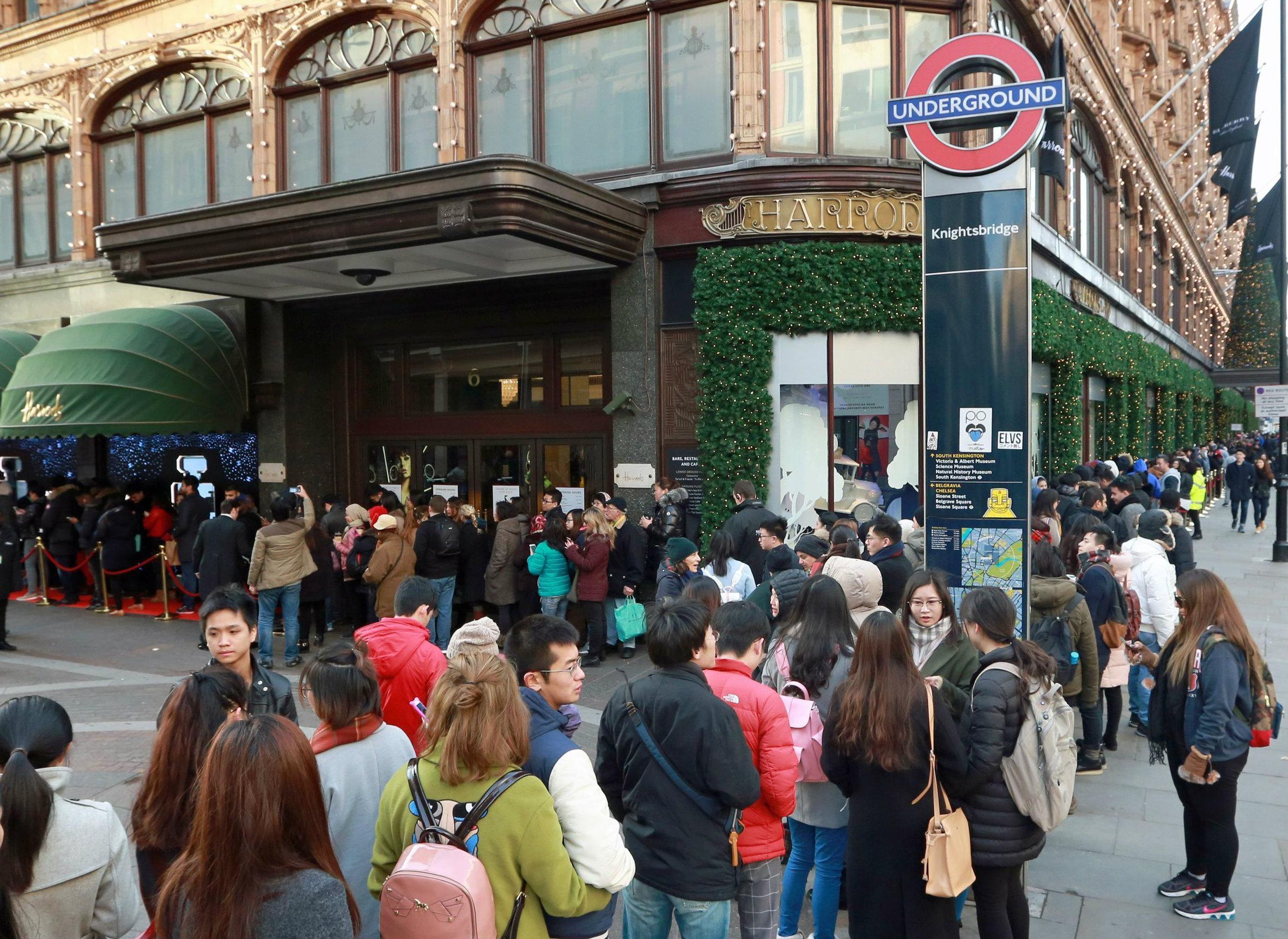 Customers queue outside Harrods in Knightsbridge, London, in preparation of the Boxing Day Sale