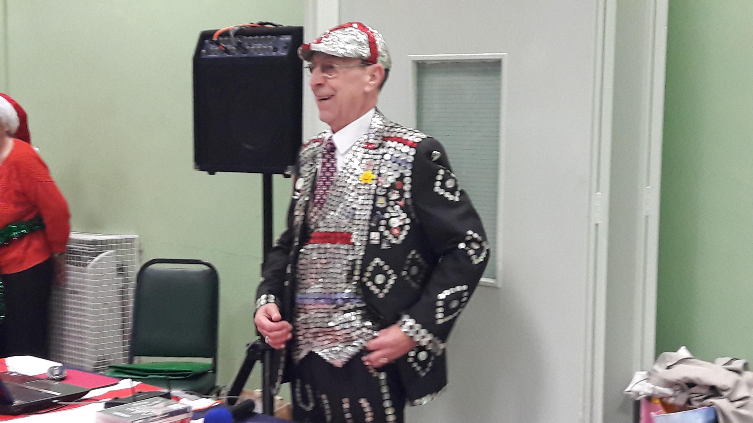 A Pearl King serenades Muslims and Christians alike as they tuck into their Christmas meal in Bethnal Green