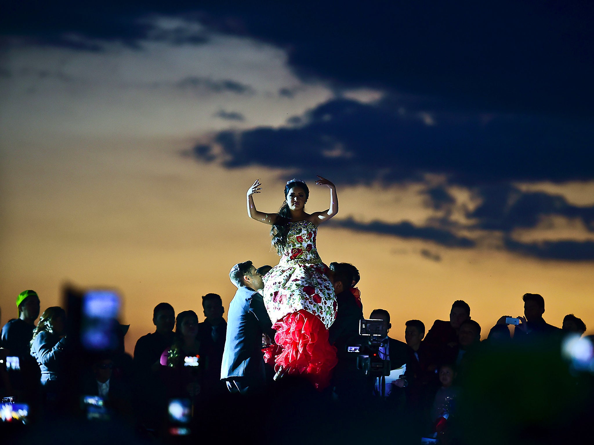 Rubi Ibarra is lifted during her 15th birthday celebrations in Villa Guadalupe