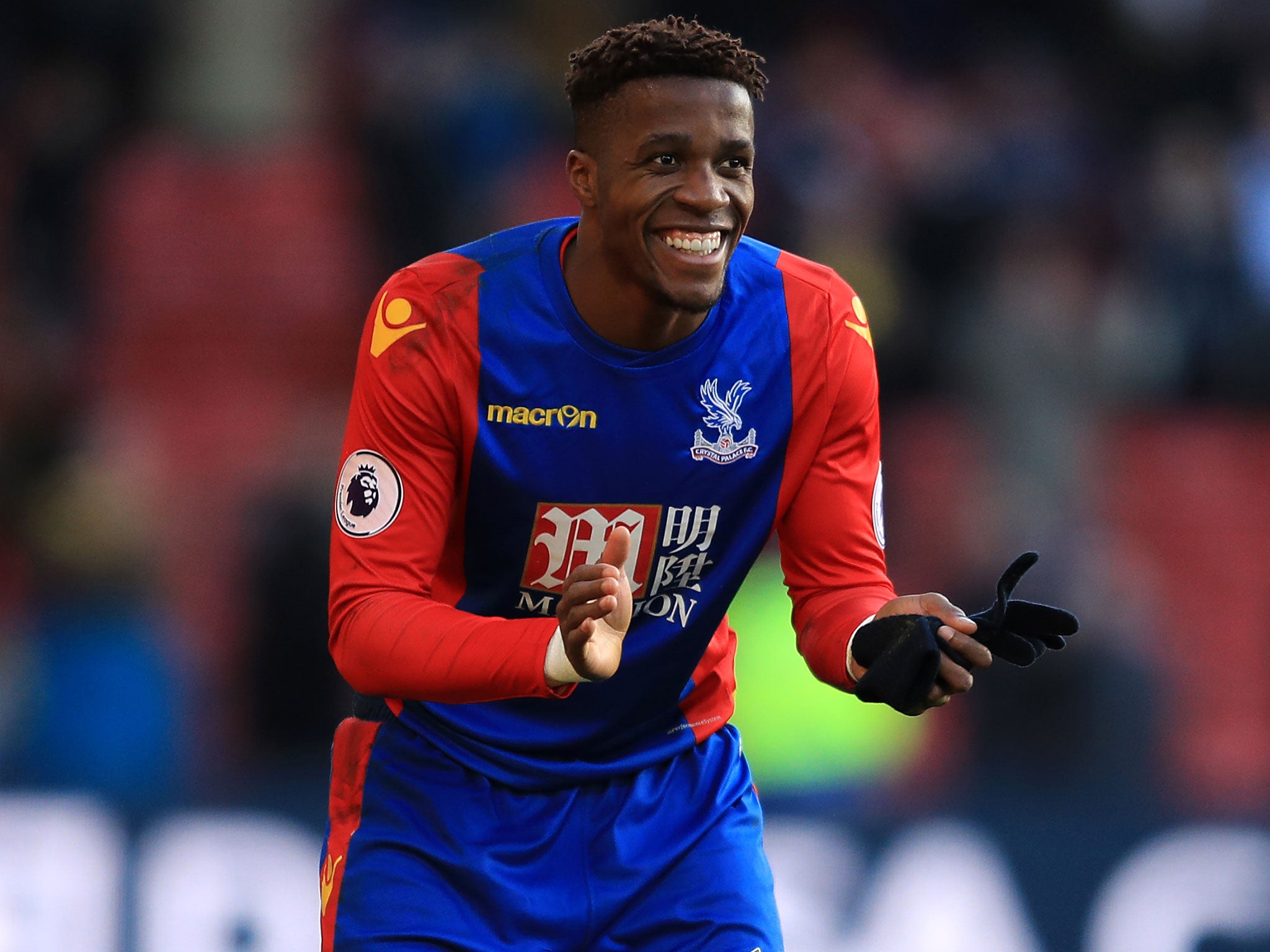 Wilfried Zaha reacted by clapping the mascot before leaving the field