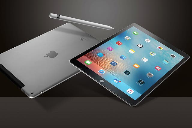 A Pair of Apple iPad Pro Tablet Devices And An Apple Pencil