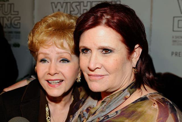 Debbie Reynolds (left) and her daughter Carrie Fisher arrive at a premiere in Hollywood, 2010