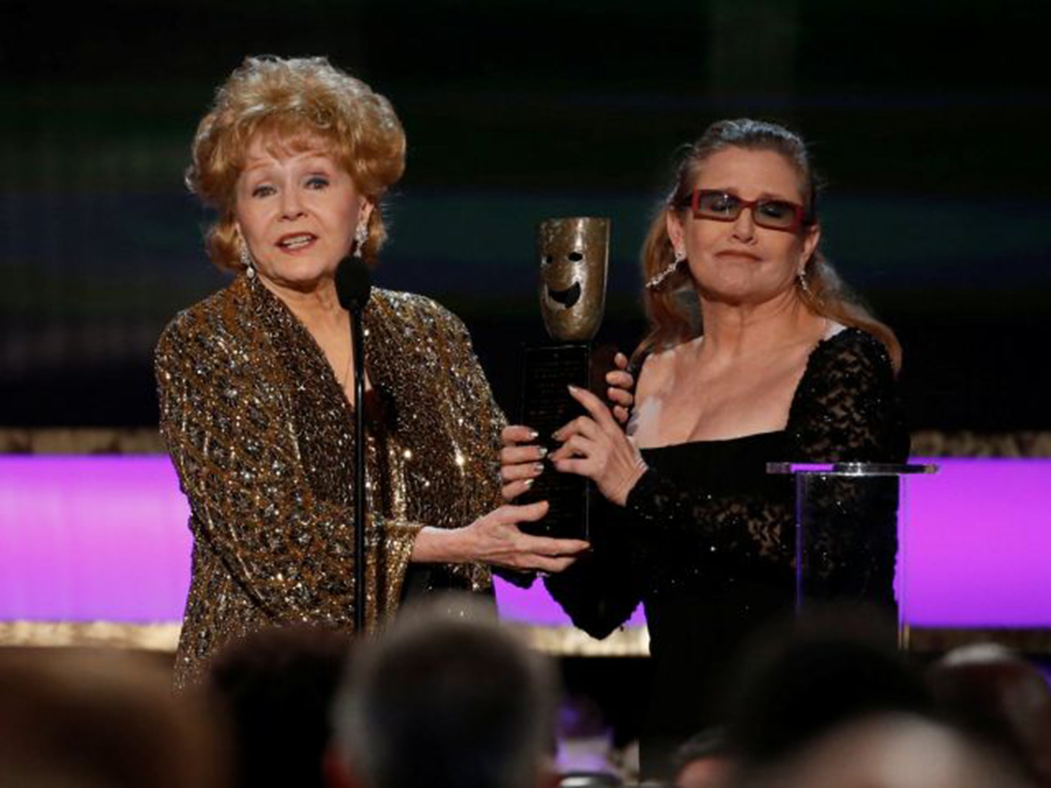 Debbie Reynolds (left) accepts the life achievement award from her daughter actress Carrie Fisher at the 21st annual Screen Actors Guild Awards in Los Angeles, 2015