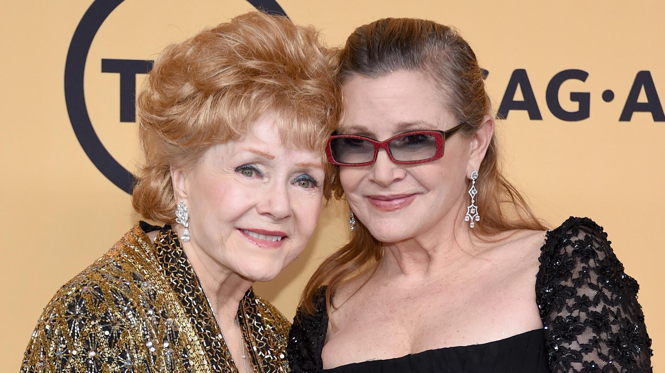 Actresses Debbie Reynolds (L), recipient of the Screen Actors Guild Life Achievement Award, and Carrie Fisher pose in the press room on January 25, 2015 in Los Angeles, California.