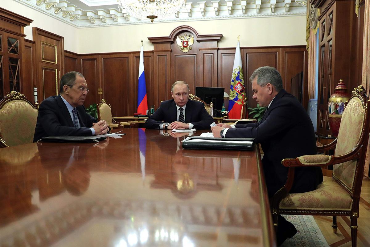 The Kremlin, where Vladimir Putin and foreign minister Sergei Lavrov (left) sit in this picture, is aggravating the refugee crisis - according to the Hungarian ex-spy