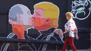 A woman walks past a mural on a restaurant wall depicting US  Presidential hopeful Donald Trump and Russian President Vladimir Putin greeting each other with a kiss in the Lithuanian capital Vilnius on May 13, 2016.
Kestutis Girnius, associate professor of the Institute of International Relations and Political Science in Vilnius university, told AFP -This graffiti expresses the fear of some Lithuanians that Donald Trump is likely to kowtow to Vladimir Putin and be indifferent to Lithuanias security concerns. Trump has notoriously stated that Putin is a strong leader, and that NATO is obsolete and expensive. 