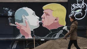 VILNIUS, LITHUANIA - NOVEMBER 23: A woman walks past a mural showing U.S. President-elect Donald Trump (R) blowing marijuana smoke into the mouth of Russian President Vladimir Putin on the wall of a bar-b-que restaurant on November 23, 2016 in Vilnius, Lithuania. Many people in the three Baltic nations of Lithuania, Latvia and Estonia are concerned that Russia, because Trump has expressed both admiration for Putin and doubt over defending NATO member states, will be emboldened to intervene militarily in the Baltics.
