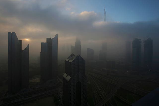 The sun rises over the skyline of Dubai