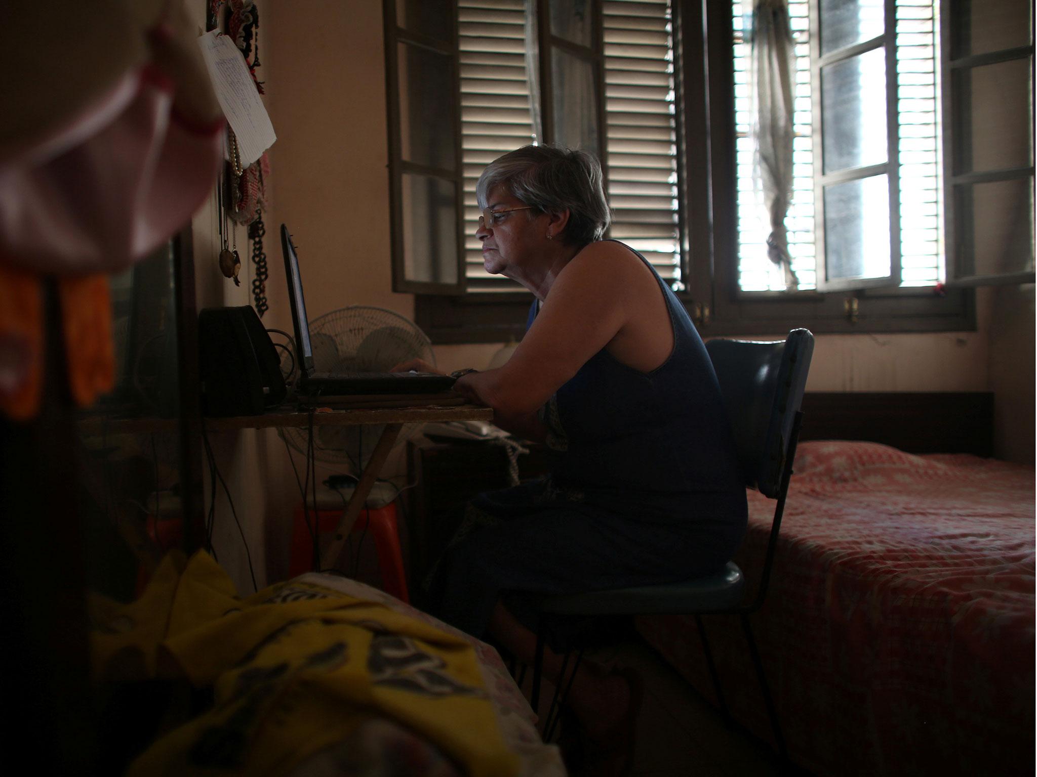 Retired teacher Margarita Marquez, 67, uses the internet after it was recently installed at her home in old Havana, Cuba, 29 December, 2016