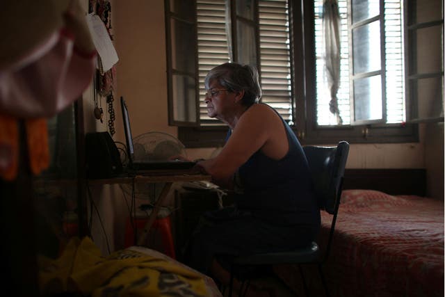 Retired teacher Margarita Marquez, 67, uses the internet after it was recently installed at her home in old Havana, Cuba, 29 December, 2016
