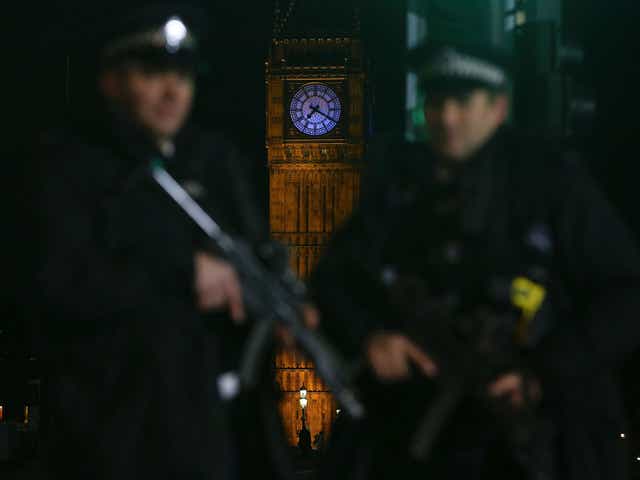 Armed police officer patrol ahead of the New Year's Eve fireworks in London on 31 December 2015