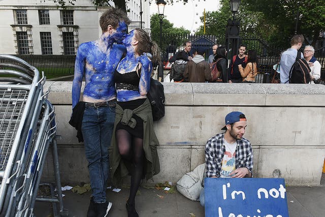 A young couple painted as EU flags, protest outside Downing Street against the United Kingdom's decision to leave the EU following the referendum  in London, United Kingdom