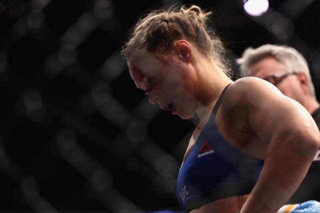 Ronda Rousey reacts with dejection after he UFC 207 knockout defeat by Amanda Nunes