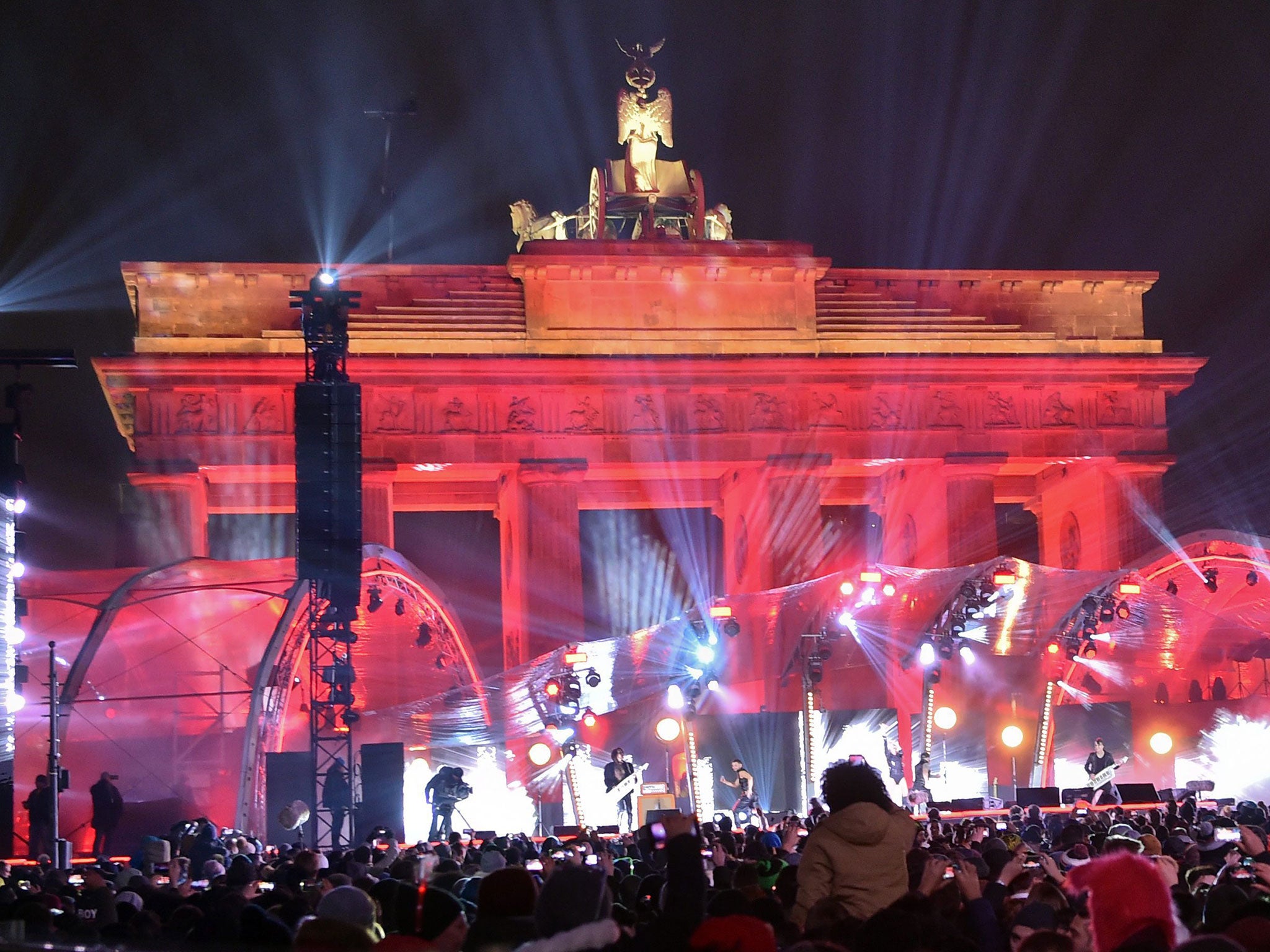 People attend the Year's Eve party by the Brandenburg Gate in Berlin, Germany, 31 December 2016.