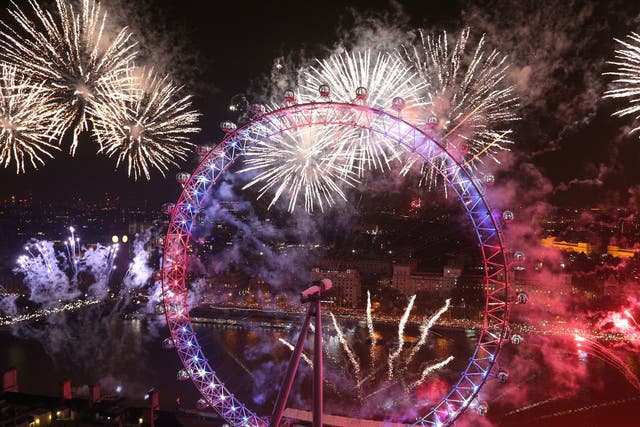 Fireworks light up the sky over the London Eye in central London during the New Year celebrations.