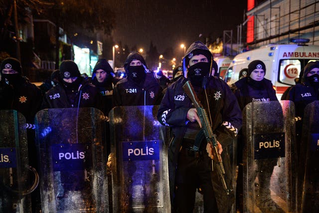 Turkish police officers block the road leading to the scene of the attack in Istanbul hours after a gunman opened fire in a busy nightclub on New Year's Eve