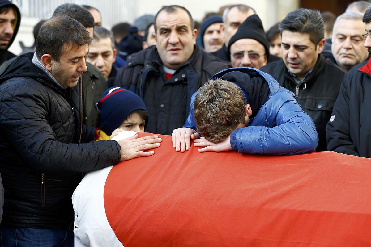 Relatives of Ayhan Arik, one of the victims of the Reina night club attack mourn during his funeral ceremony yesterday