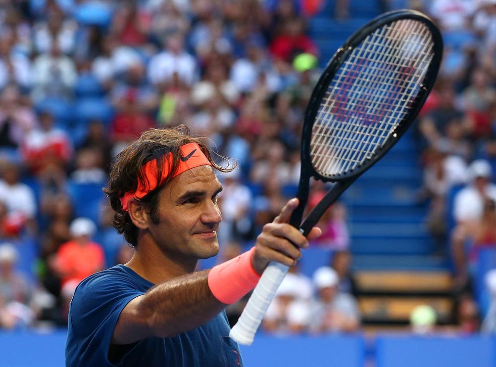 Roger Federer acknowledges the crowds during the Hopman Cup in Perth