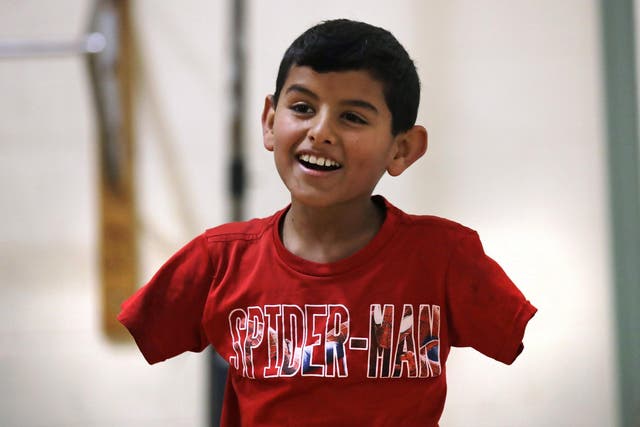 'Anything is possible in this world. You just have to believe in yourself,' says Ahmad, 11, whose arms were blown off above the elbows in a bomb blast at a refugee camp in Syria that killed three of his siblings in 2014